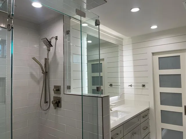 a bathroom with a shower and a mirror