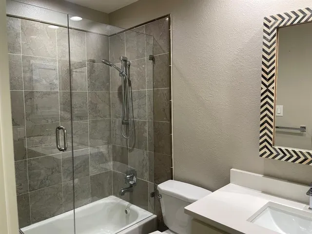 a bathroom with a shower and a toilet