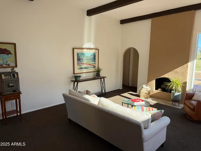 a bedroom with a bed and painting on the wall