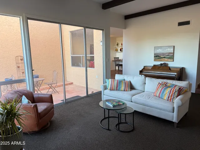 a view of a grassy field with mountains in the background