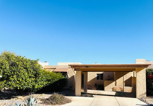 a living room with furniture a flat screen tv and a painting on the wall