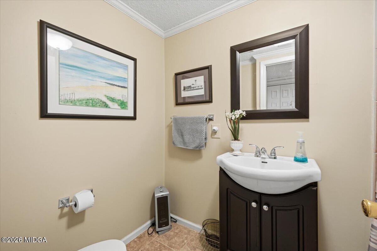 214 Howard Roberts Road Gray, GA 31032 - Photo 21 of 36 a bathroom with a sink and a mirror