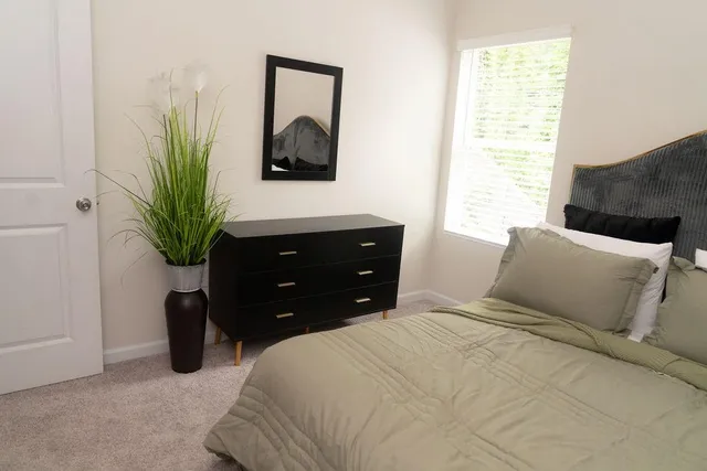 a bedroom with a bed and a window