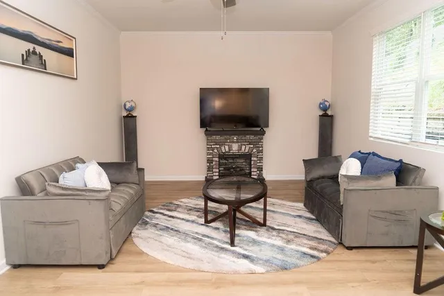 a living room with furniture and a flat screen tv