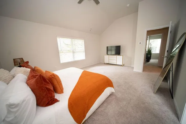 a bedroom with a bed and a flat tv screen