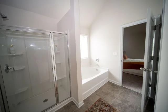 a bathroom with a tub and shower