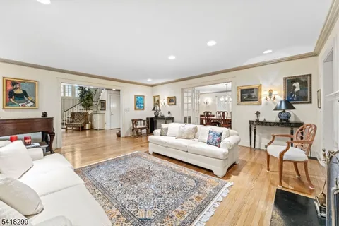 a dining room with furniture a chandelier and wooden floor