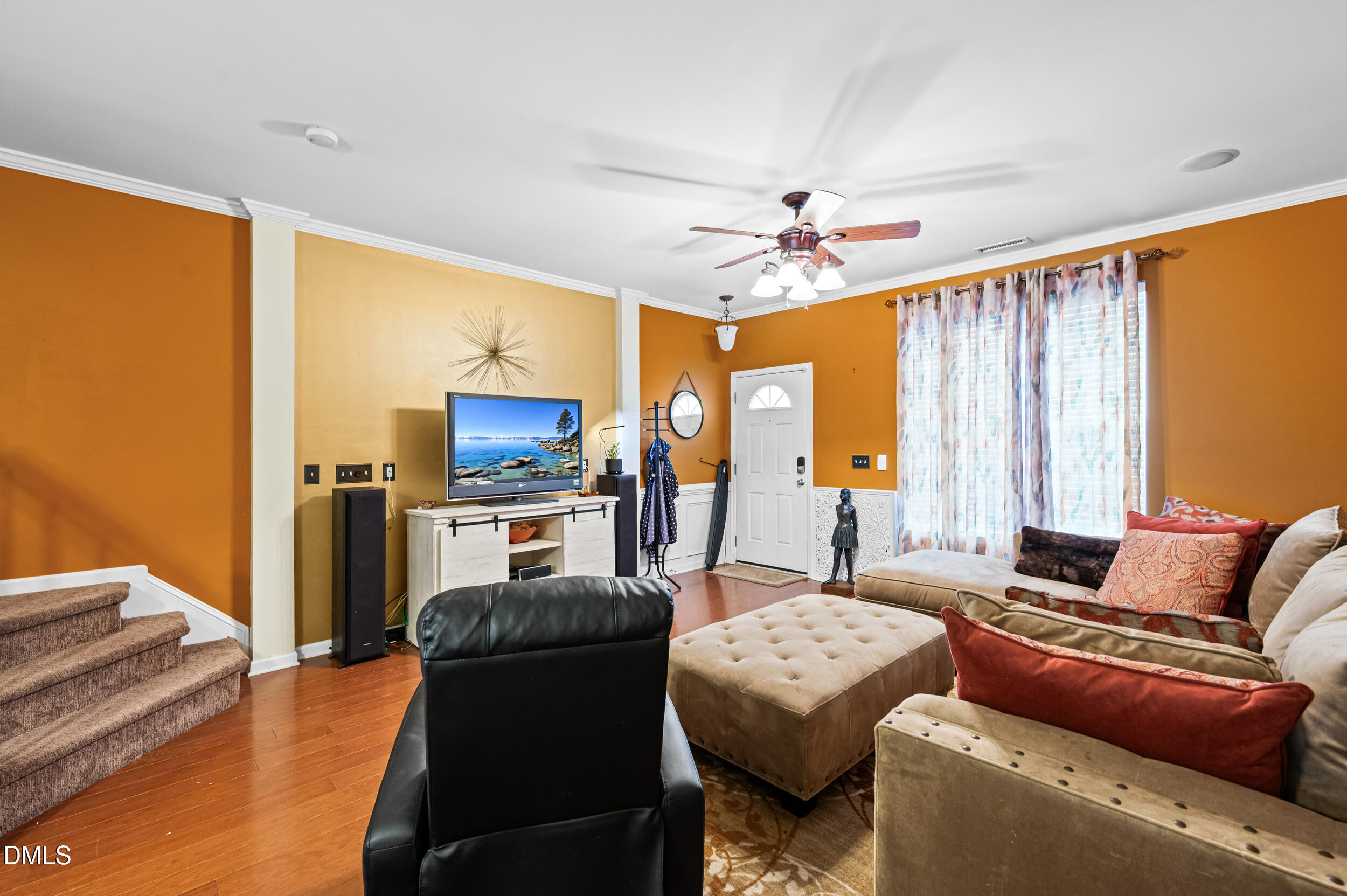 2944 Casona Way Raleigh, NC 27616 - Photo 5 of 24 a living room with furniture and a flat screen tv