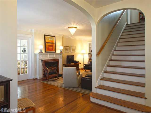 2109 Rolling Road Greensboro, NC 27403 - Photo 2 of 16 Entry. Open the door to wonderful architectural features. Note the arches, wood floors and interior French doors and wide staircase.