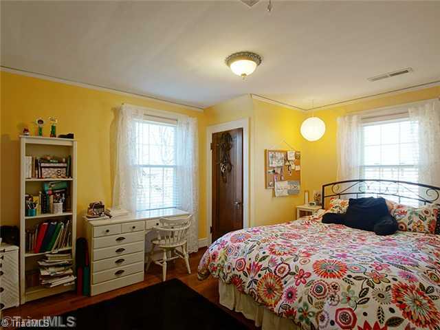 2109 Rolling Road Greensboro, NC 27403 - Photo 12 of 16 2nd Bedroom. This cheerful yellow room has two closets, one of them cedar lined.