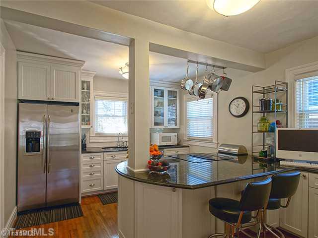2109 Rolling Road Greensboro, NC 27403 - Photo 7 of 16 Kitchen. Kitchen updated with granite counter tops and stainless steel appliances. Beautiful glass doors in some of the upper cabinets. There is also a pantry.