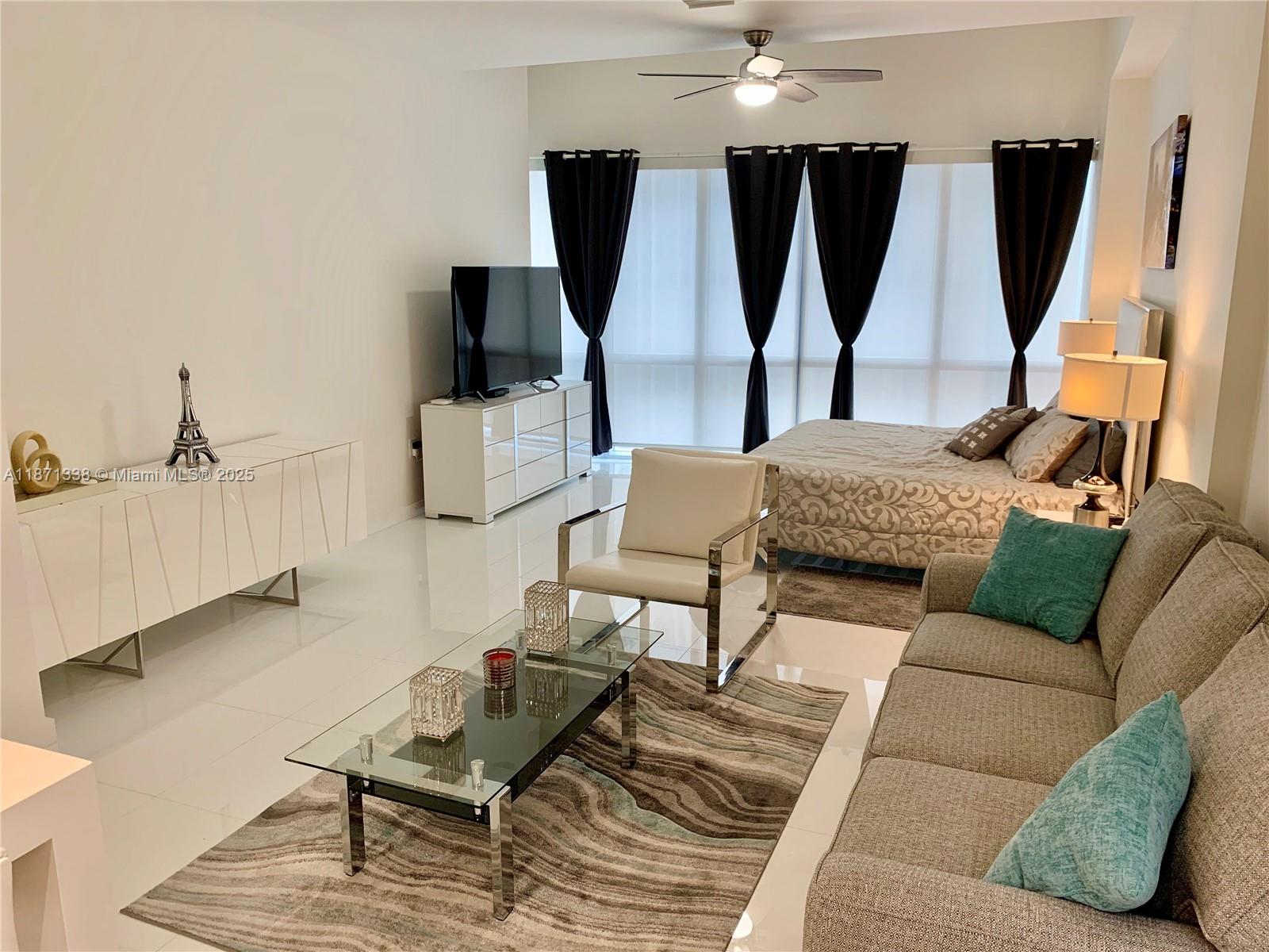 851 Northeast 1st Avenue, Unit 502 Miami, FL 33132 - Photo 11 of 48 a living room with furniture and a flat screen tv