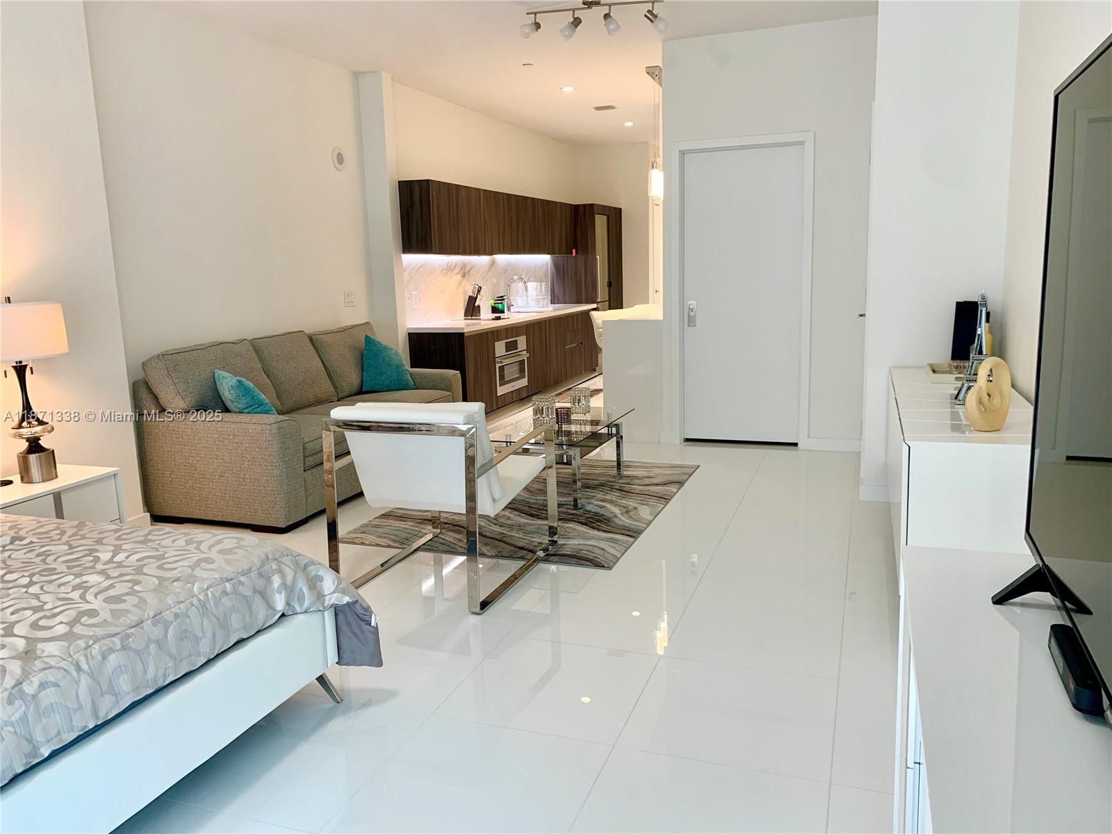 851 Northeast 1st Avenue, Unit 502 Miami, FL 33132 - Photo 12 of 48 a living room with furniture and a flat screen tv