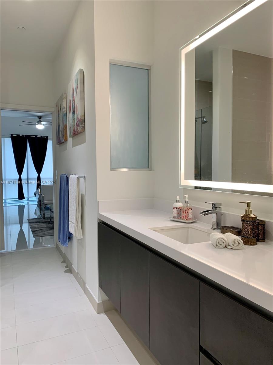 851 Northeast 1st Avenue, Unit 502 Miami, FL 33132 - Photo 14 of 48 a en suite bathroom with a sink and a mirror