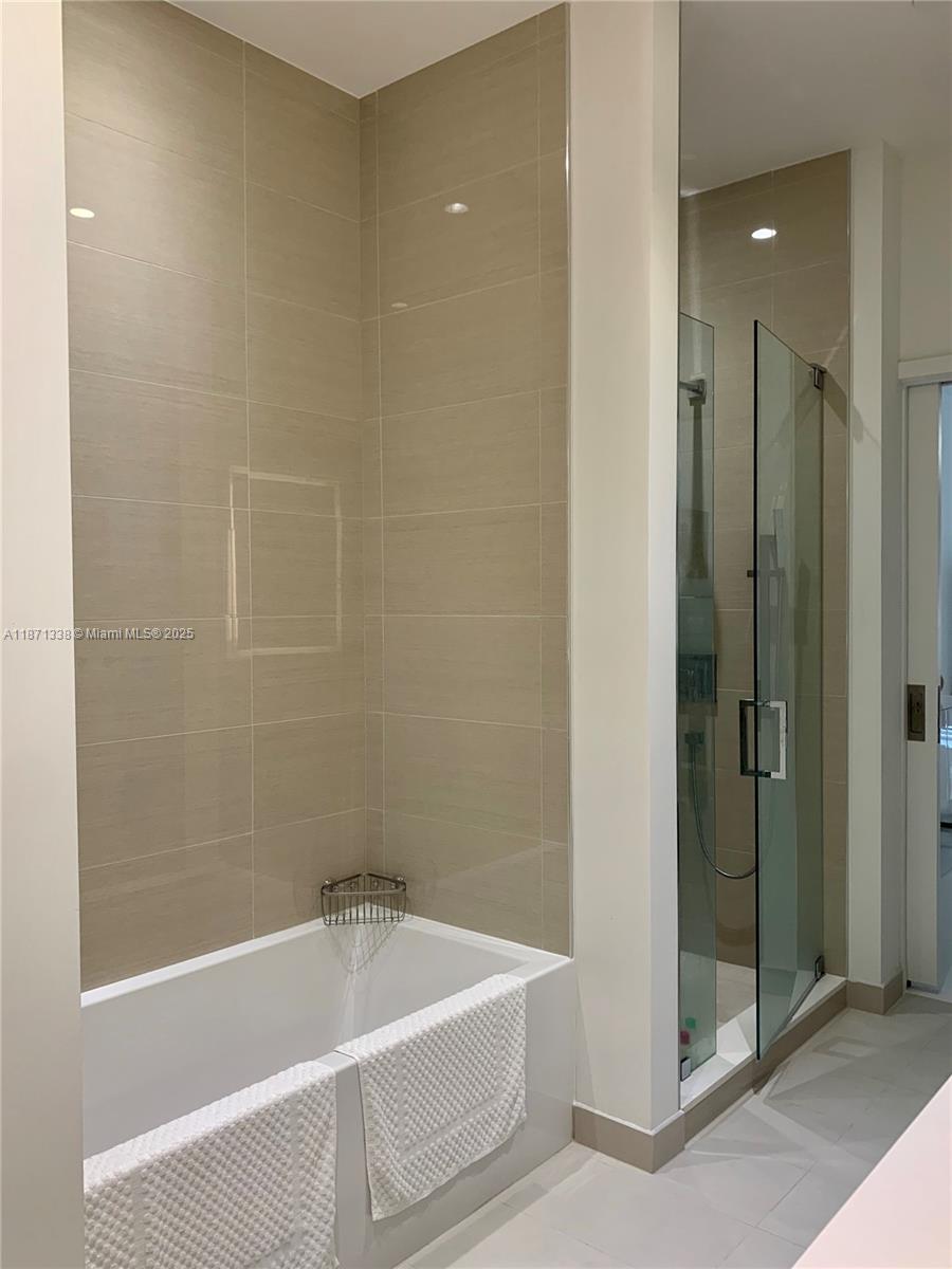 851 Northeast 1st Avenue, Unit 502 Miami, FL 33132 - Photo 15 of 48 a bathroom with a tub and shower