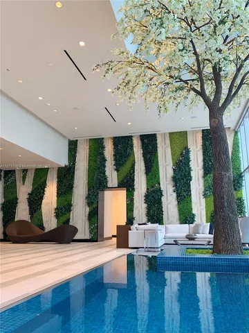 a living room with large windows and furniture