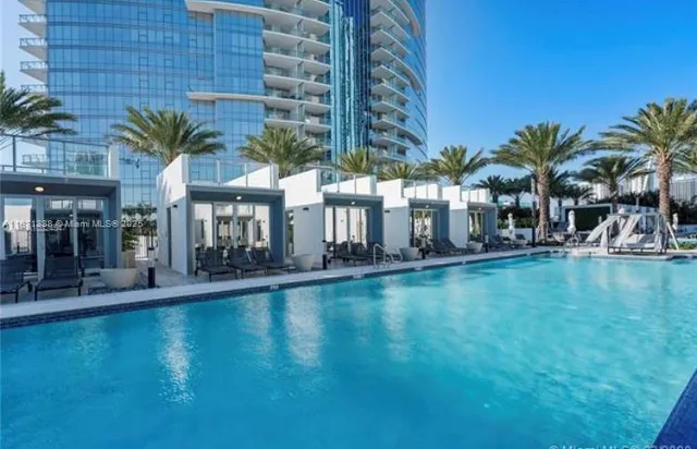 a swimming pool with outdoor seating and yard