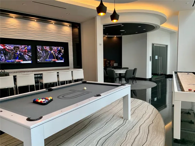 a dining room with furniture and a window