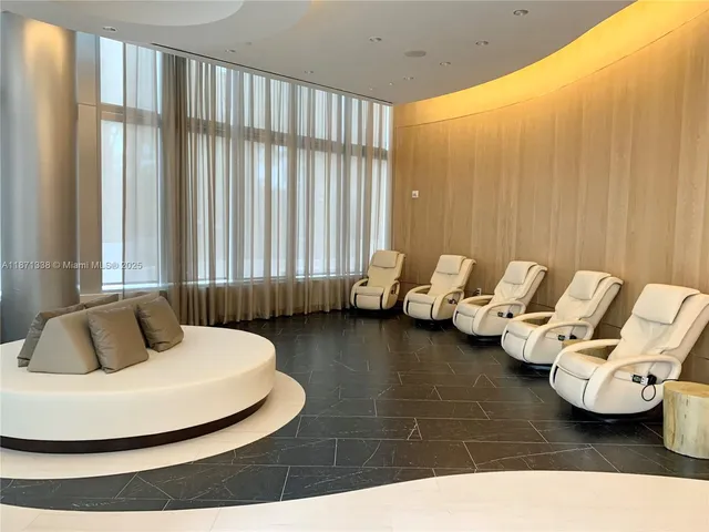 a room with a chair and a potted plant