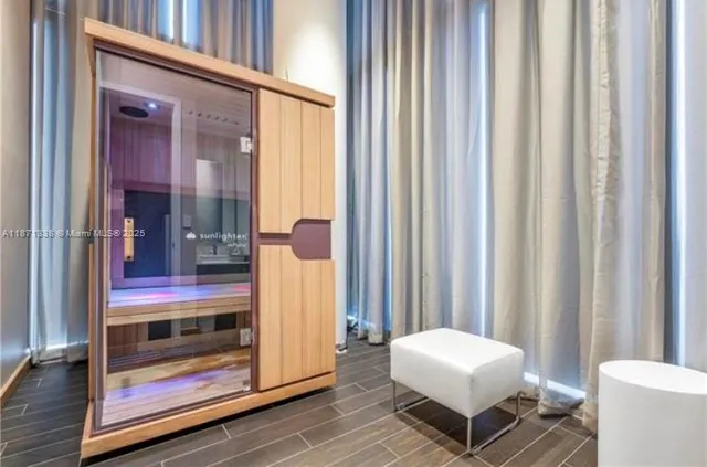 a dining room with wooden floor a glass table and chairs