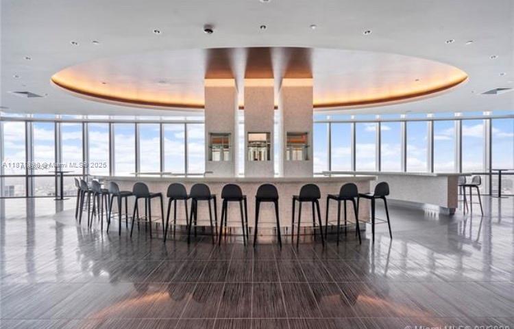 851 Northeast 1st Avenue, Unit 502 Miami, FL 33132 - Photo 44 of 48 a dining room with wooden floor a glass table and chairs