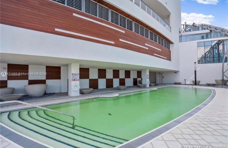 851 Northeast 1st Avenue, Unit 502 Miami, FL 33132 - Photo 45 of 48 a view of a house with pool backyard and sitting area