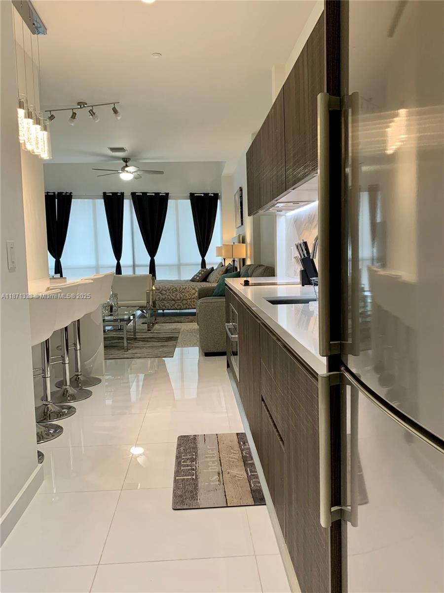 851 Northeast 1st Avenue, Unit 502 Miami, FL 33132 - Photo 5 of 48 a kitchen with lots of appliances and cabinets