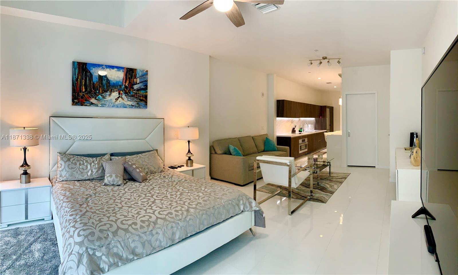851 Northeast 1st Avenue, Unit 502 Miami, FL 33132 - Photo 10 of 48 a bedroom with a bed a couch and a chandelier