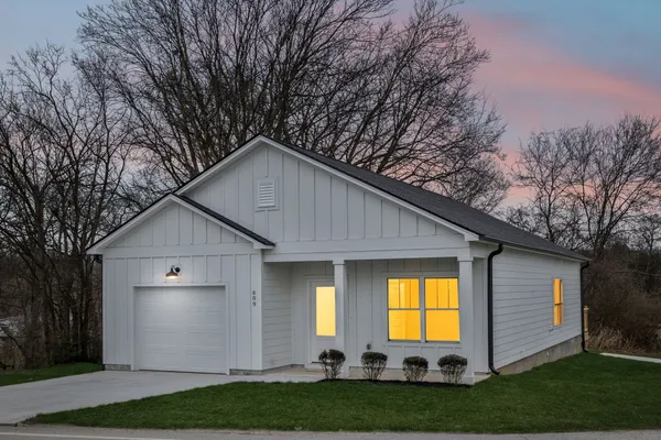 a view of a house with a yard and plants