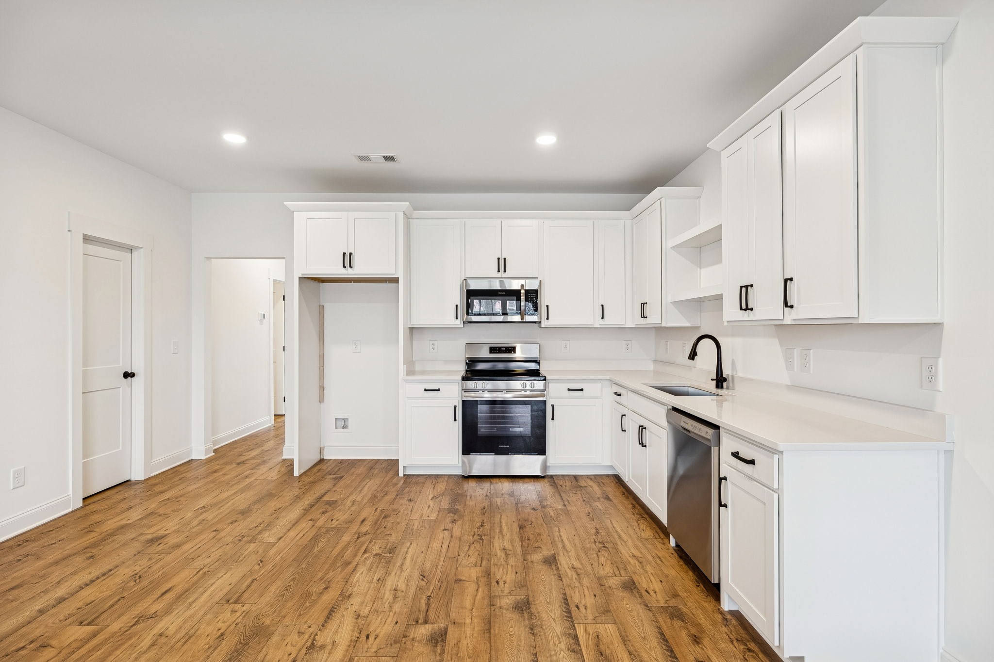 609 South Main Street Mount Pleasant, TN 38474 - Photo 11 of 37 a kitchen with stainless steel appliances granite countertop a stove and a refrigerator