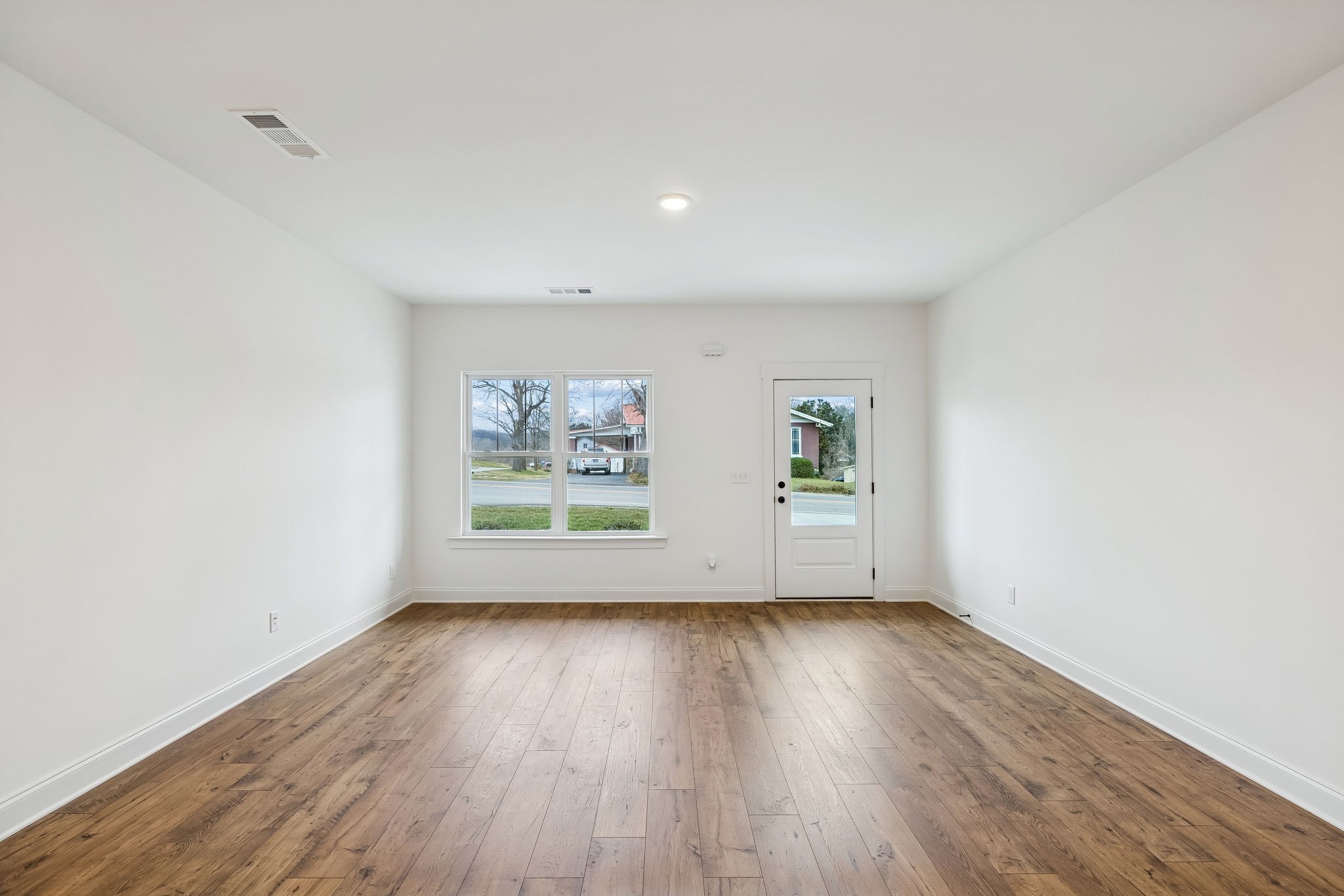 609 South Main Street Mount Pleasant, TN 38474 - Photo 14 of 37 an empty room with wooden floor and windows