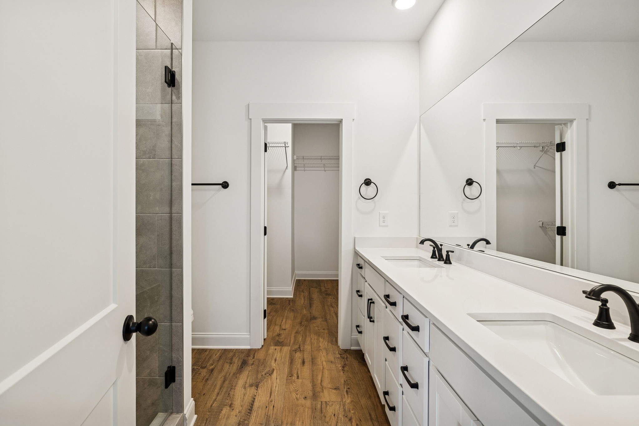 609 South Main Street Mount Pleasant, TN 38474 - Photo 25 of 37 a bathroom with a double vanity sink a mirror and a shower