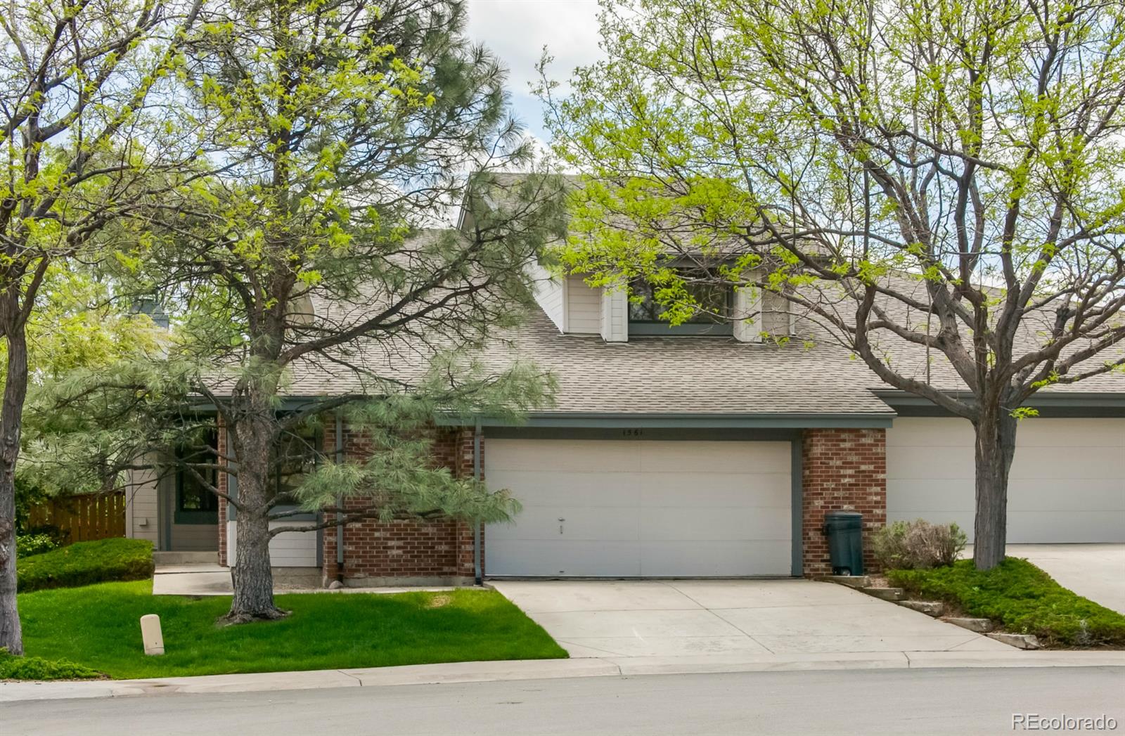 1561 Northcrest Drive Highlands Ranch, CO 80126 - Photo 1 of 1 a front view of a house with garden