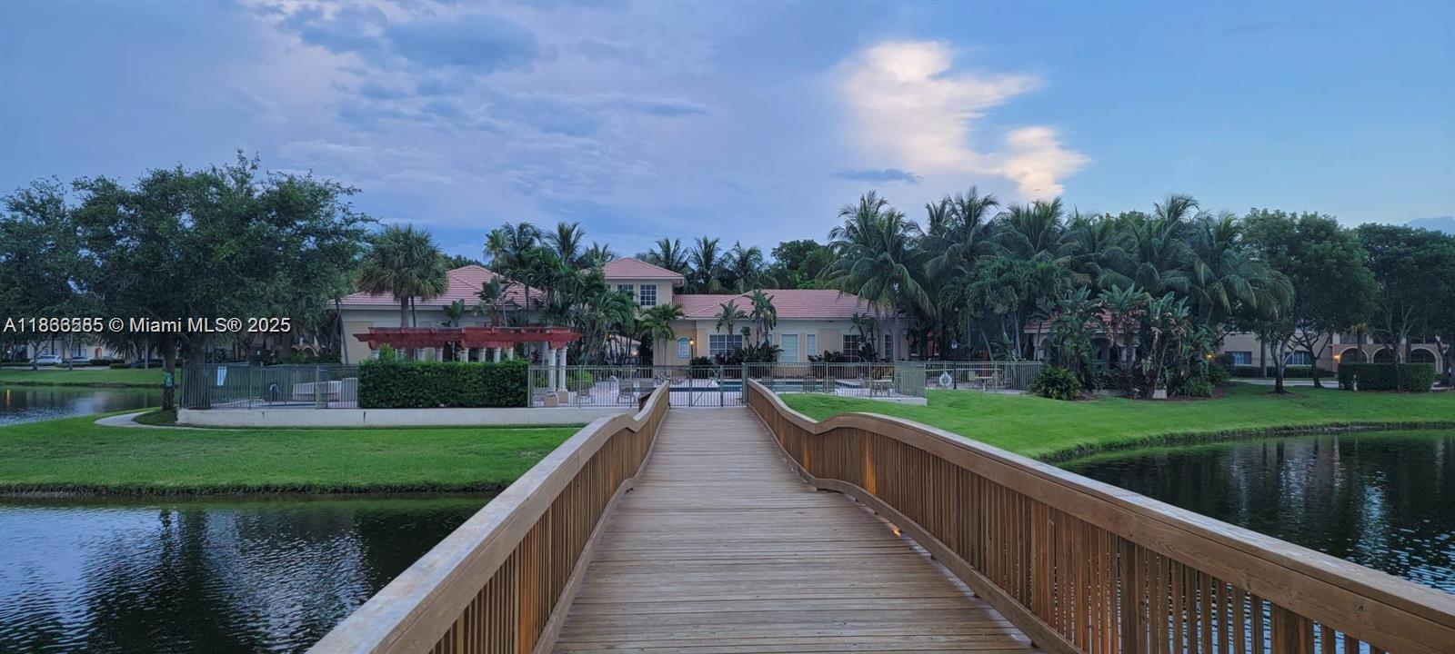 2564 Centergate Drive, Unit 304 Miramar, FL 33025 - Photo 13 of 13 a view of a lake with a garden
