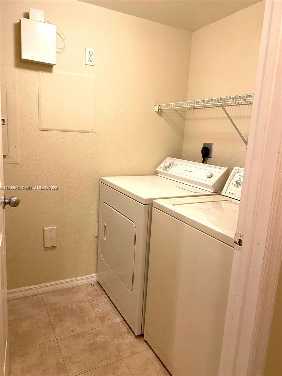 2564 Centergate Drive, Unit 304 Miramar, FL 33025 - Photo 7 of 13 a utility room with dryer and washer