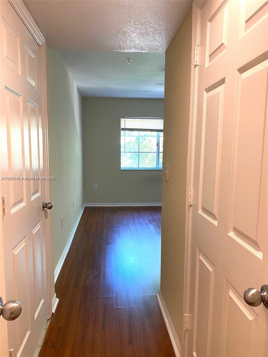 2564 Centergate Drive, Unit 304 Miramar, FL 33025 - Photo 9 of 13 a view of hallway with hardwood floor