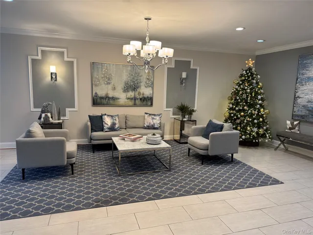 a living room with furniture or chandelier and a rug