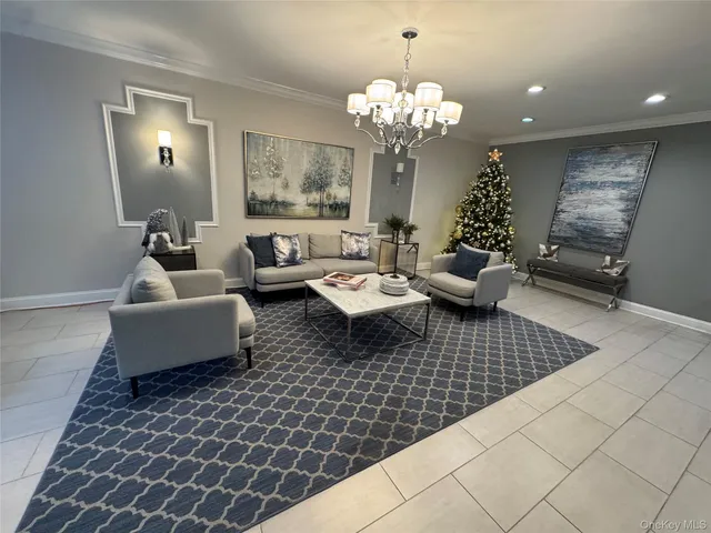 a living room with furniture and a chandelier