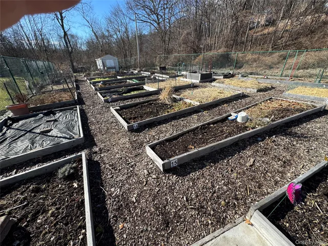 a view of a yard with wooden fence