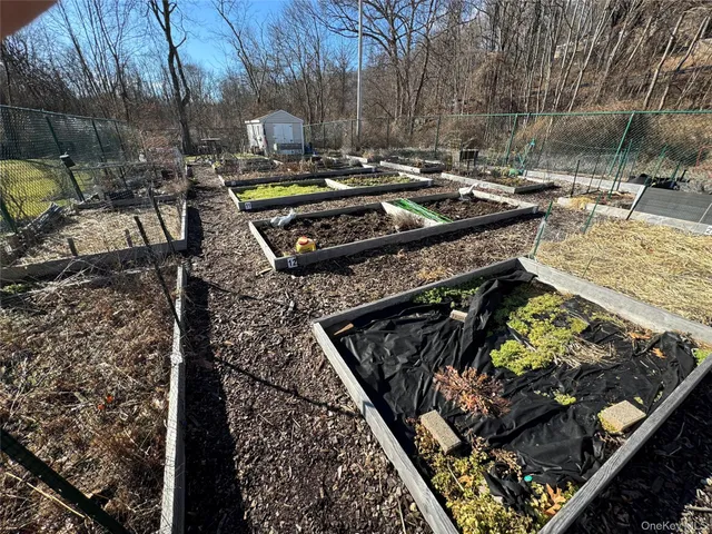 a view of a backyard with fountain and a barbeque