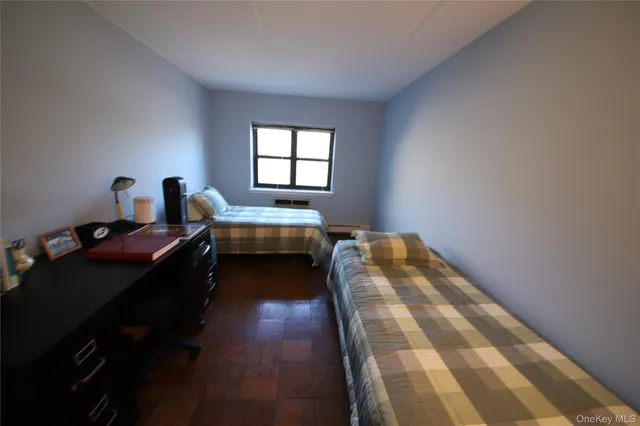 a bed room with two beds and a window