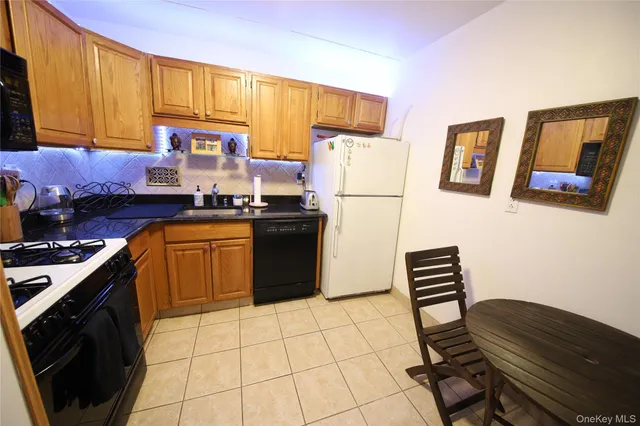 a kitchen with a stove a refrigerator and a sink