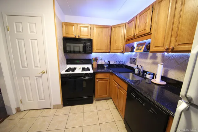 a kitchen with stainless steel appliances granite countertop a stove top oven a sink and dishwasher