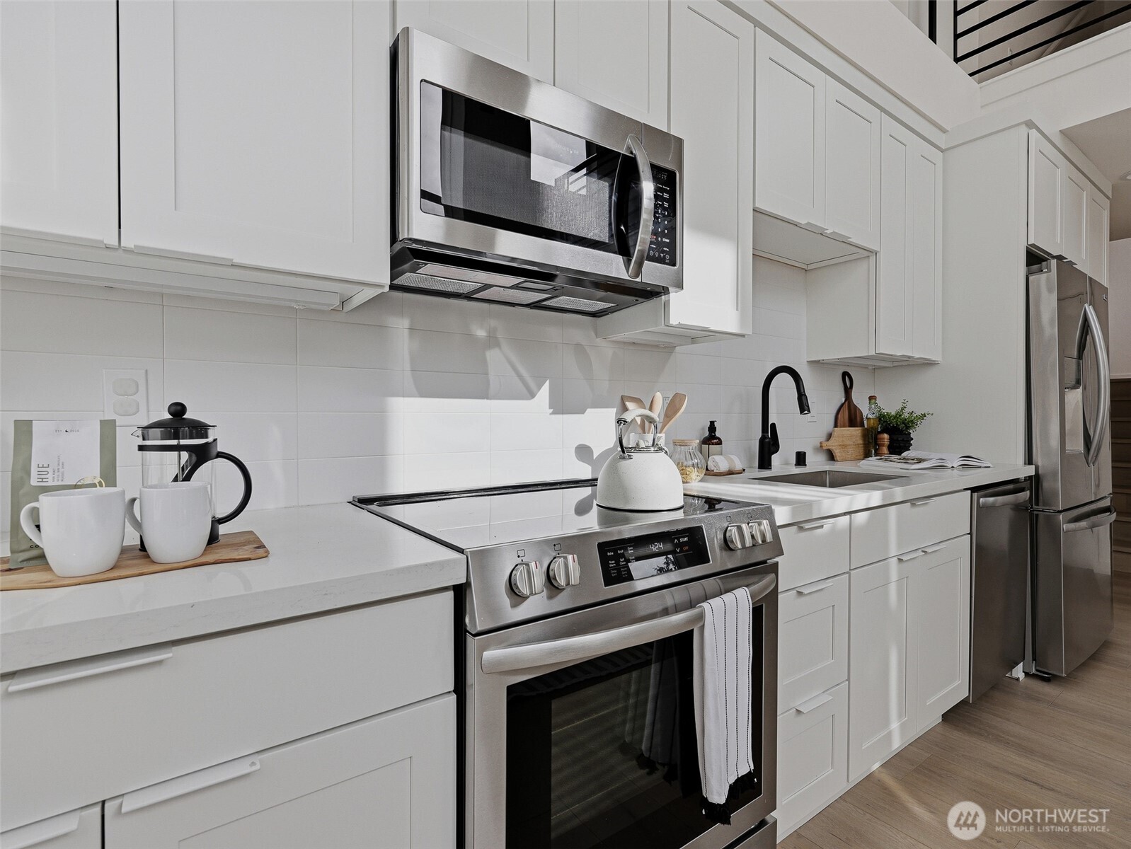 6320 41st Avenue Southwest, Unit A Seattle, WA 98136 - Photo 10 of 39 a kitchen with stainless steel appliances granite countertop a sink a stove a microwave and cabinets