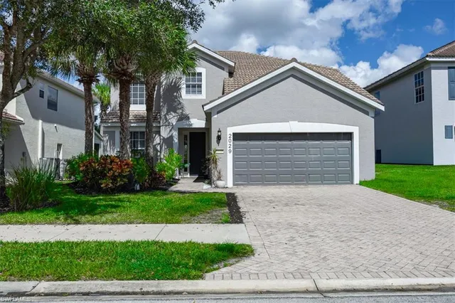 a front view of a house with a yard and garage