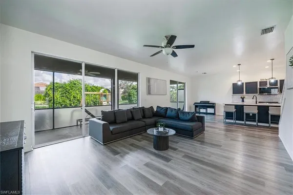 a living room with furniture and a large window
