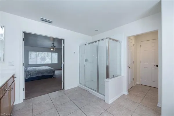 a bedroom with a bed and a view of en suite bathroom