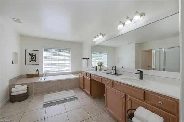 a large bathroom with a granite countertop sink a toilet and bathtub