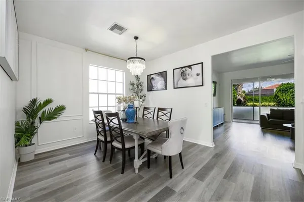 a view of a dining room with furniture and wooden floor