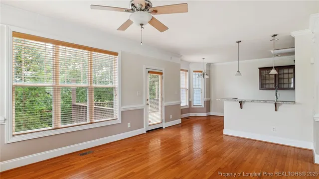 a view of an empty room with window and fire place